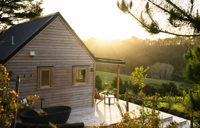 Outdoor bath and deck overlooking the Paroa Bay vineyard